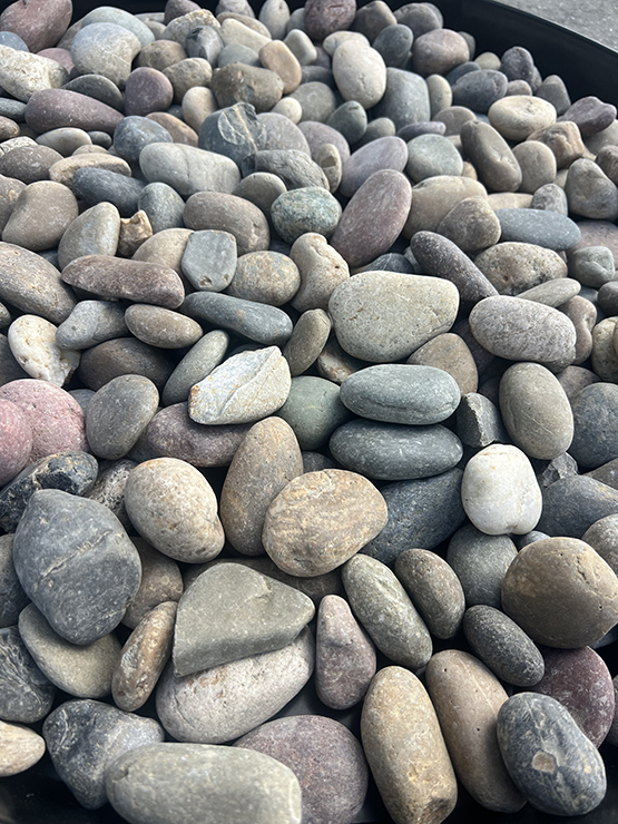 Blasted confetti pebbles installed in landscape bed
